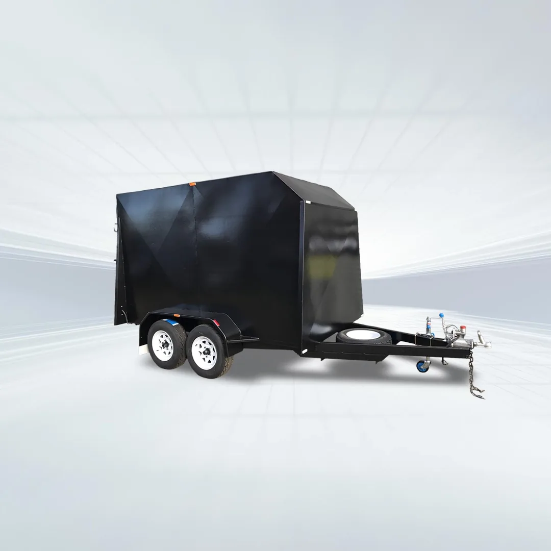 Studio shot of black 10x6 enclosed trailer with 3200kg GVM, 7ft internal height, tandem axles, spare wheel, and full rear ramp on white background.