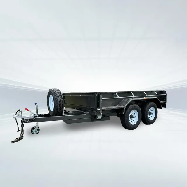 Studio rear angled view of black 10x6 tandem tipper trailer with hydraulic ram and high sides on white background.