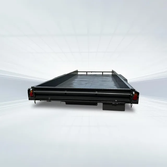 Rear studio view of black 16ft x 6ft6in car trailer with 3200kg GVM, 10-inch sides, checker plate deck, and slide-in ramps.