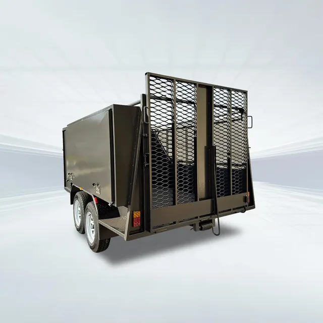 Studio rear angled view of black 8x5 lawn mowing trailer with mesh sides and grip mesh ramps on white background.